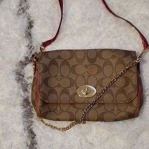 Coach crossbody with pink strap and trim.